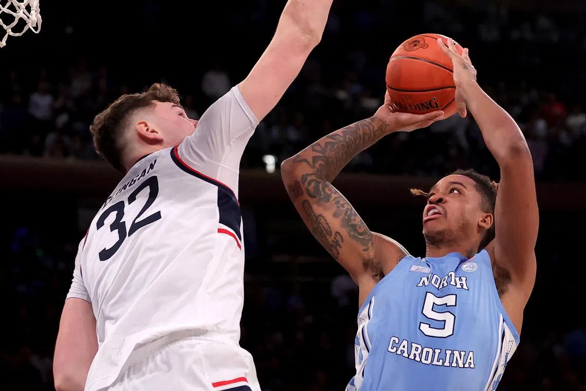 North Carolina Tar Heels forward Armando Bacot drives to the basket against Connecticut Huskies centre Donovan Clingan during an NCAA match.