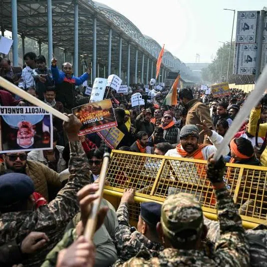 Security personnel try to stop protestors rallying against the killing of Dipu Chandra Das, near the Bangladesh High Commission in New Delhi on Dec 23.