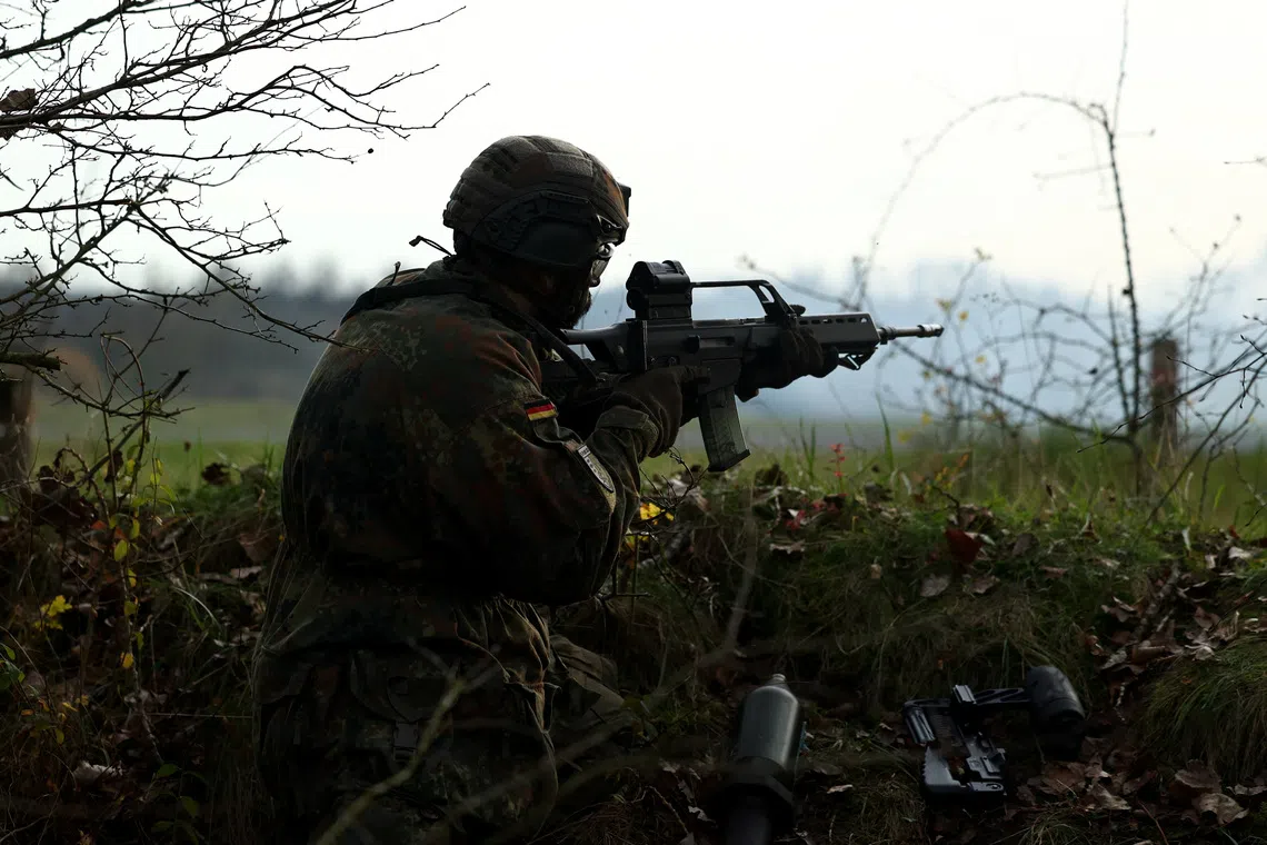 A recruit shoots his G-36 rifle at a training drill during a media day at the Reconnaissance Battalion, as the German army showcases its new six-month basic training program designed to prepare soldiers for homeland defence and NATO operations, in Ahlen, Germany, November 13, 2025. REUTERS/Leon Kuegeler