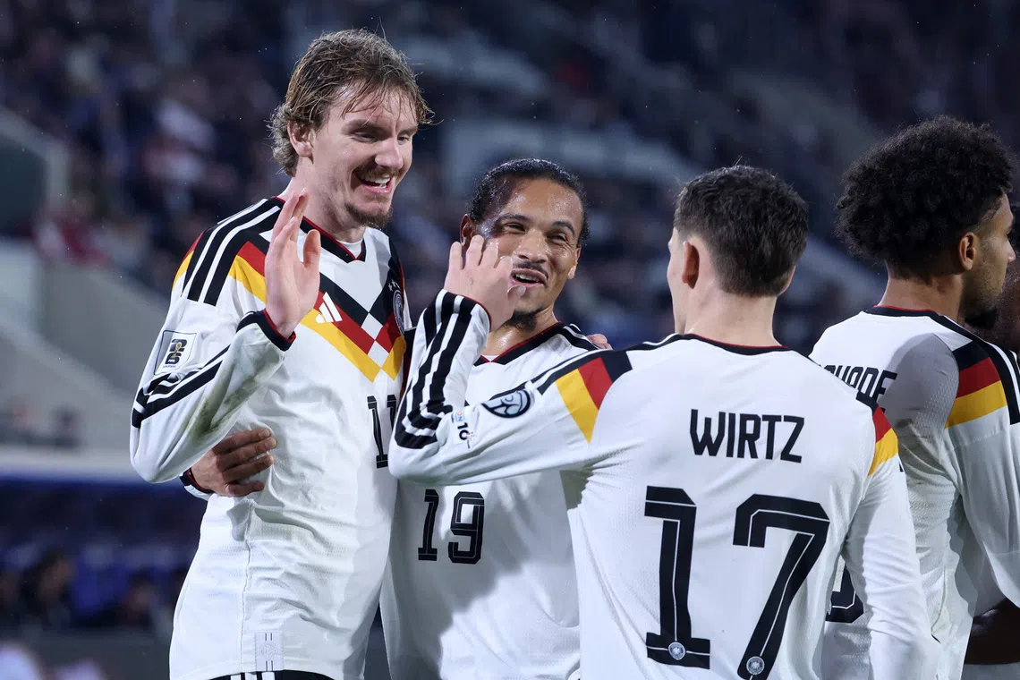Soccer Football - World Cup - UEFA Qualifiers - Group A - Luxembourg v Germany - Stade de Luxembourg, Luxembourg City, Luxembourg - November 14, 2025 Germany's Nick Woltemade celebrates scoring their second goal with Leroy Sane and Florian Wirtz REUTERS/Omar Havana