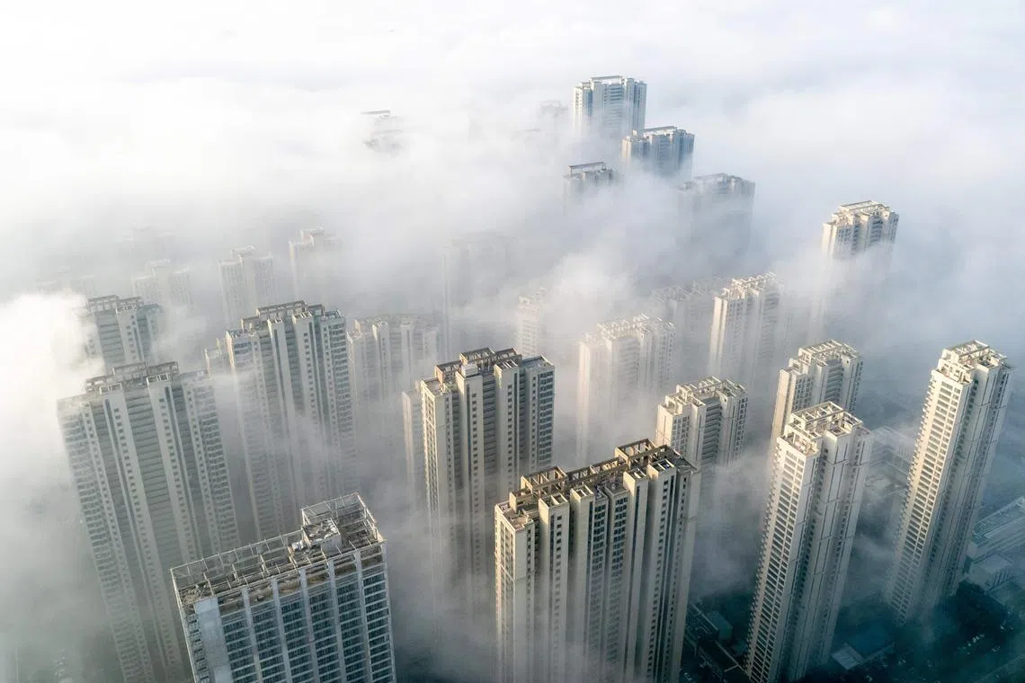 This aerial photo taken on November 27, 2023 shows fog over residential buildings in Wuhan, in China's central Hubei province. (Photo by AFP) / China OUT