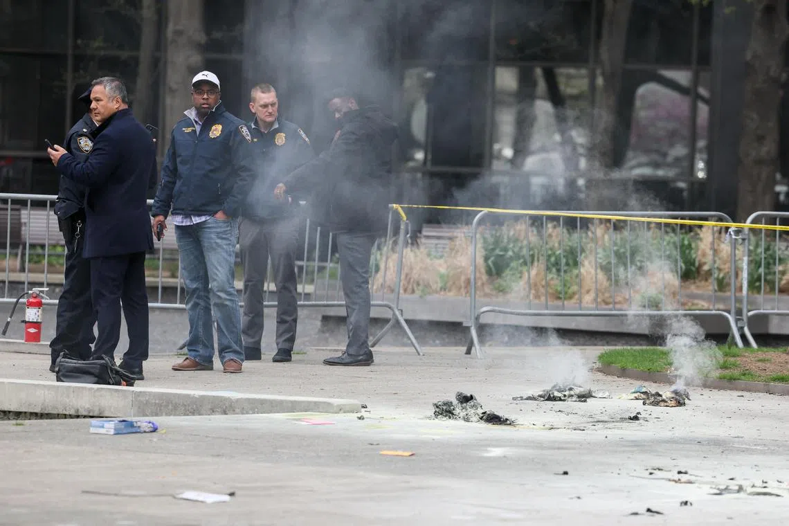 Emergency personnel work at the scene after a man set himself on fire outside the courthouse where former US president Donald Trump is on trial over hush money paid to a porn star.