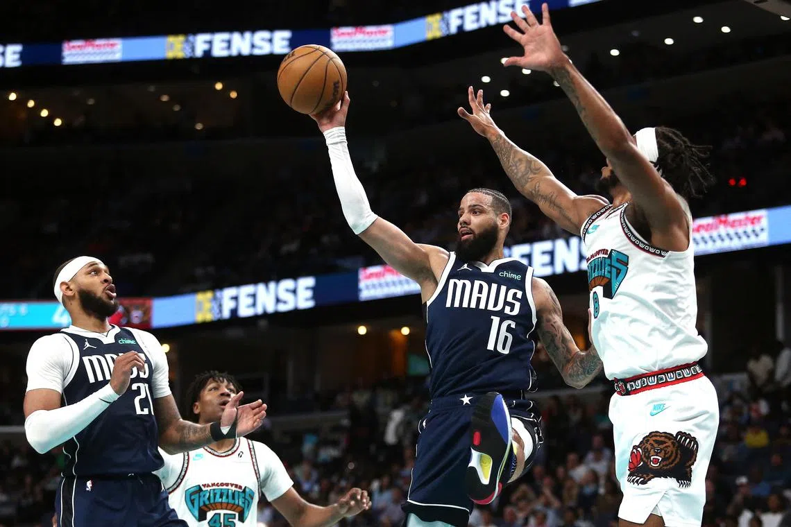Dallas Mavericks forward Caleb Martin passes the ball as Memphis Grizzlies forward Lamar Stevens defends during the second quarter at FedExForum. 