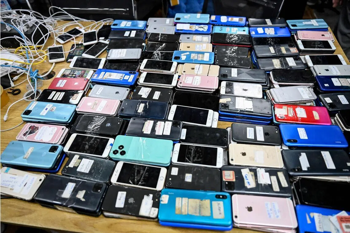 Seized smartphones seized from a cyberscam operation centre pictured on March 11.