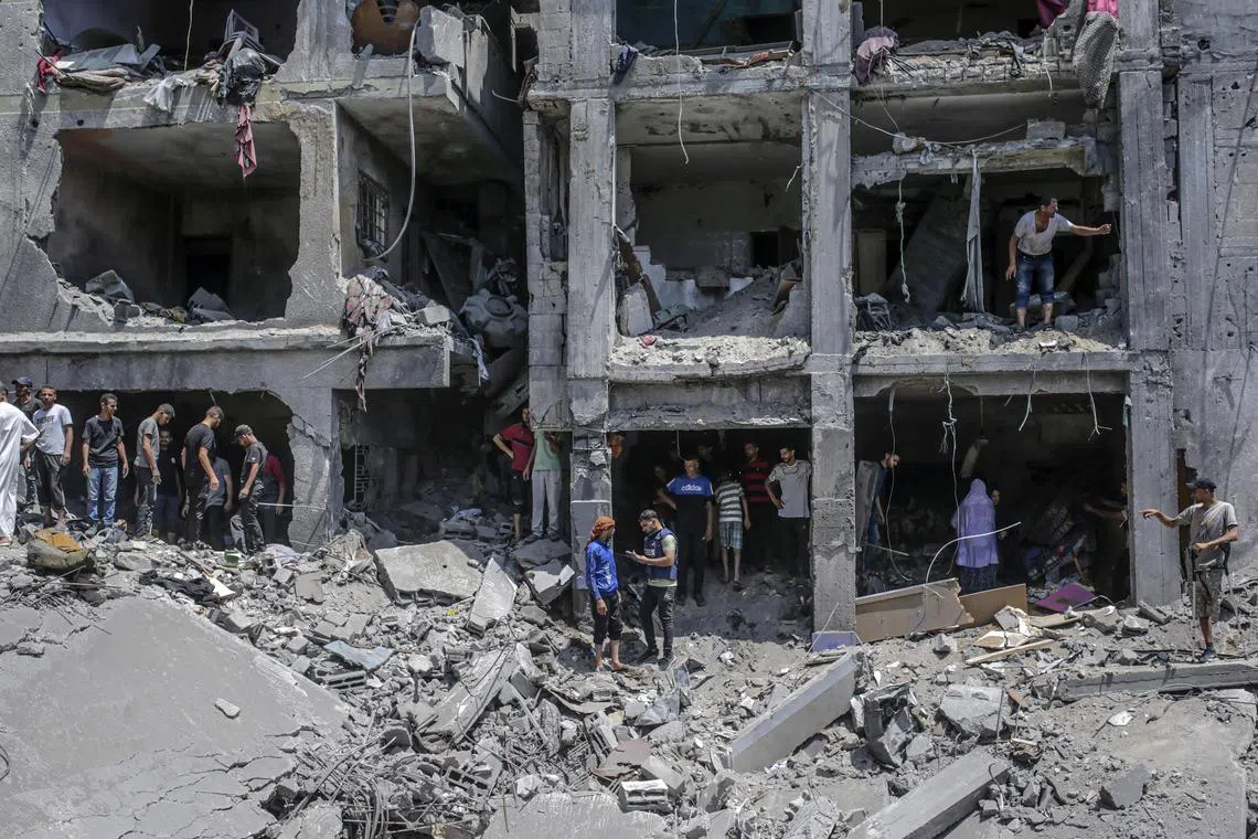 Palestinians search for bodies and survivors in the rubble of a destroyed house, following an Israeli airstrike on the Al Sabra neighbourhood in Gaza City, on June 7.