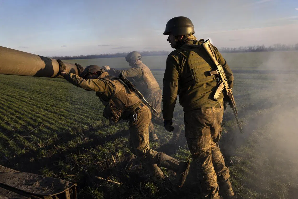 Soldiers from a Ukrainian artillery brigade quickly set up a 155mm howitzer in an open field to fire on Russian armoured infantry vehicles spotted near the front line, in the Zaporizhzhia region of Ukraine on Dec 14, 2022.