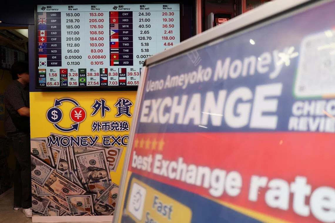 Exchange rates of Japanese Yen to the US dollar and several other foreign currencies are displayed at a money exchange shop in Tokyo.