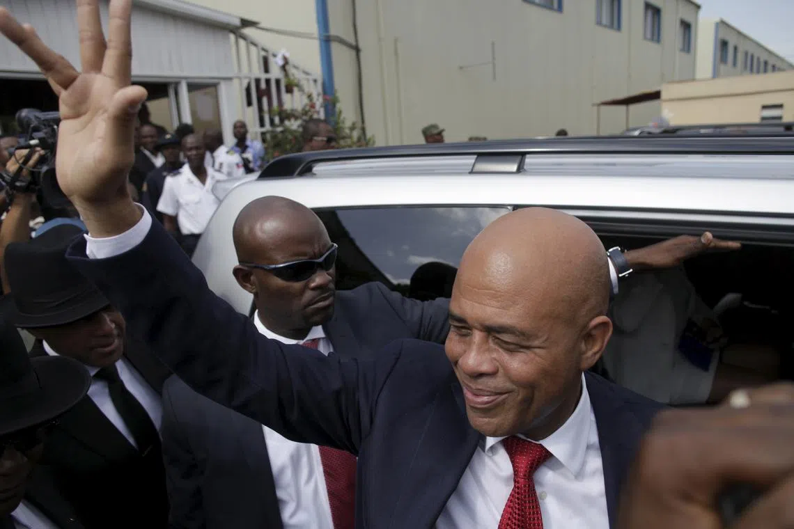 FILE PHOTO: Haiti's former President Michel Martelly says goodbye after a ceremony marking the end of his presidential term, at the Haitian Parliament in Port-au-Prince, Haiti, February 7, 2016. REUTERS/Andres Martinez Casares/File Photo