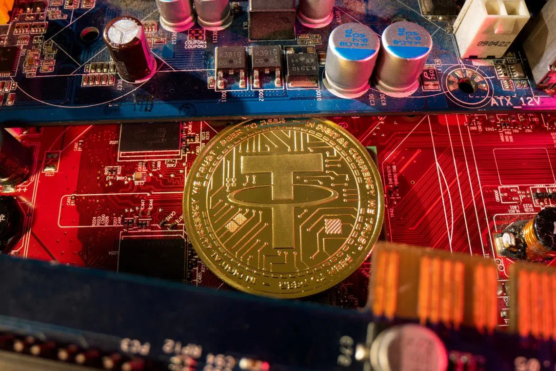 FILE PHOTO: A representation of cryptocurrency Tether is placed on a PC motherboard, in this illustration taken June 16, 2023. REUTERS/Dado Ruvic/Illustration/File Photo