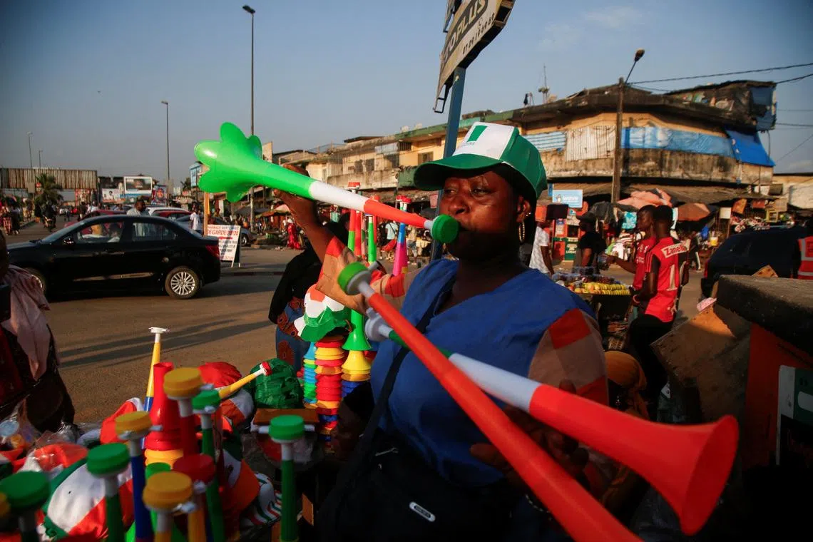 FILE PHOTO: A vendors plays Vuvuzelas while people in Abidjan are getting excited as Ivory Coast gears up to host the Africa Cup of Nations which begins on Saturday in Abidjan, Ivory Coast January 10, 2024. REUTERS/Luc Gnago/ File Photo