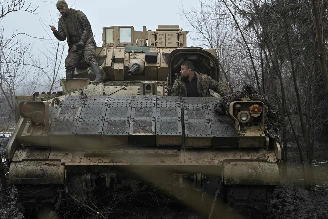 Ukrainian servicemen prepare for combat in a US-made Bradley fighting vehicle, not far away from Avdiivka, in Ukraine's Donetsk region.