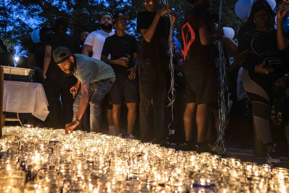 Mourners light candles during a memorial for Jasai Guy, 14, after he was shot dead by his 12-year-old cousin in Brooklyn on June 3.