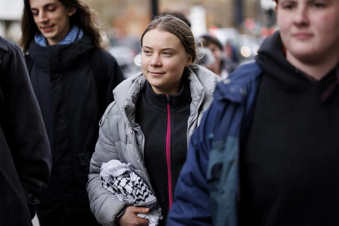 epa11120643 Swedish environmental activist Greta Thunberg (C) arrives at Westminster Magistrates Court during the lunch break in London, Britain, 02 February 2024. Thunberg has pleaded not guilty to a public order offense charge at a London protest. The campaigner was arrested on 17 October 2023 while protesting outside the Energy Intelligence Forum.  EPA-EFE/TOLGA AKMEN