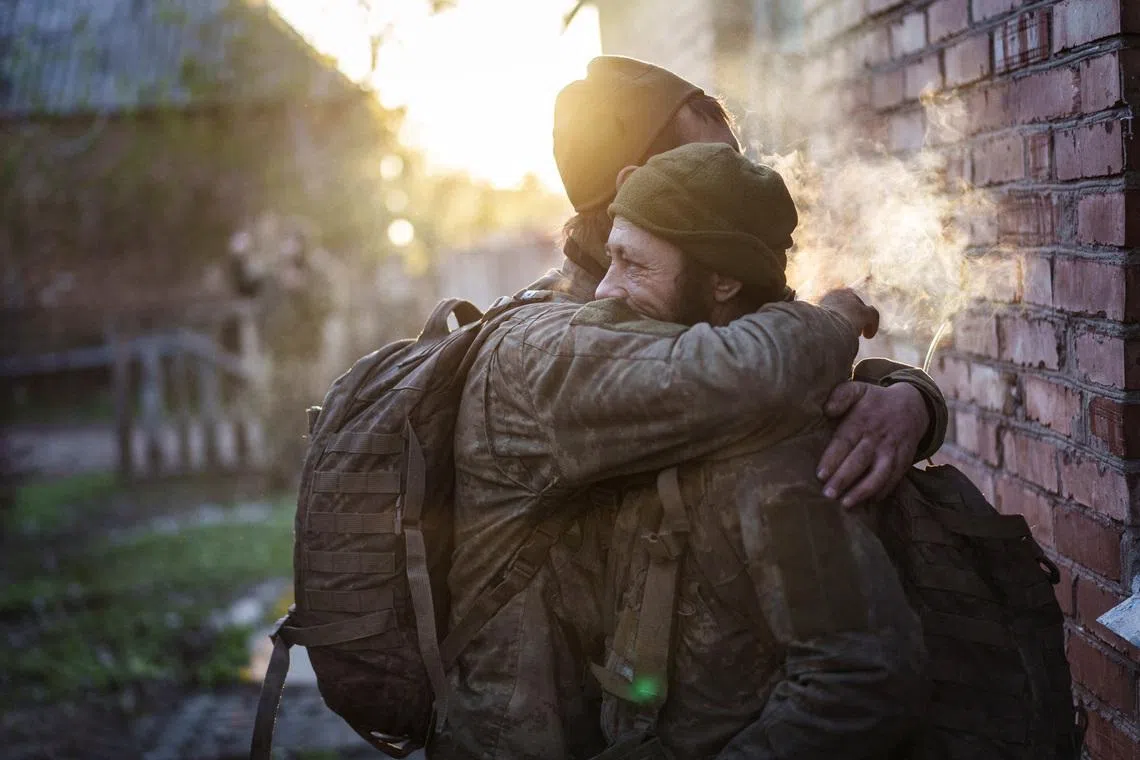 Servicemen of the Ukrainian Armed Forces, Andrii and Vasyl, hugging after returning from a frontline position, amid Russia's attack on Ukraine, in Donetsk region, Ukraine April 29.