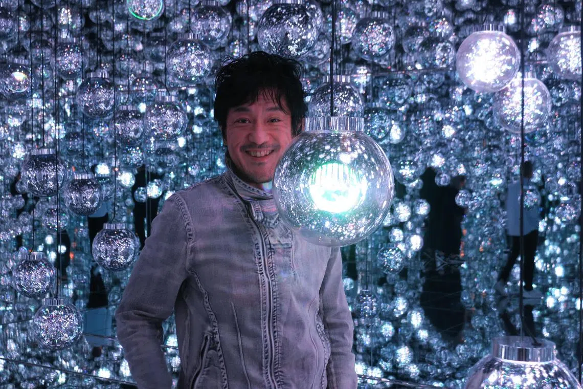 Mr Toshiyuki Inoko, founder of the teamLab art collective, poses at the Bubble Universe: Physical Light, Bubbles Of Light, Wobbling Light, And Environmental Light - One Stroke installation at the art collective's Borderless gallery in Azabudai Hills complex.