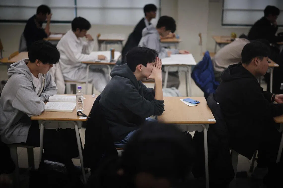 Students wait for the start of the annual college entrance exam, known locally as Suneung, at an exam hall in Seoul, on Nov 13.