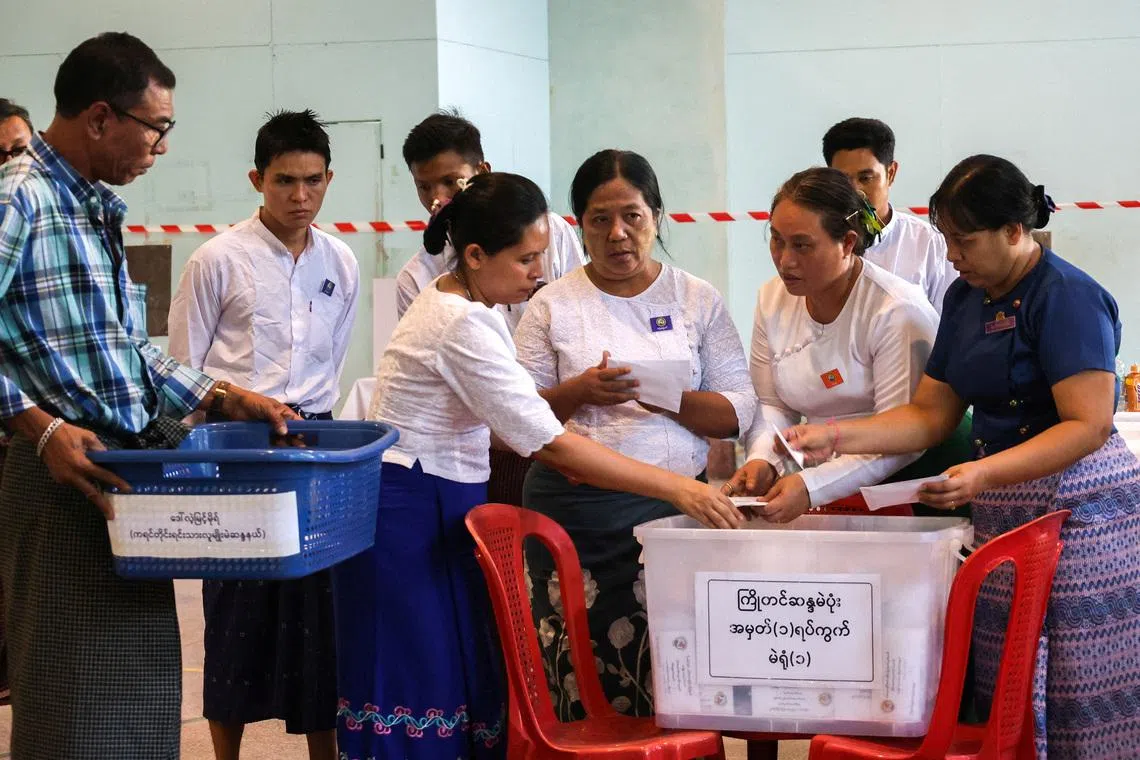 FILE PHOTO: Election Commission officials count ballots at a polling station during Myanmar's general election in Yangon, Myanmar, December 28, 2025. REUTERS/Stringer/File Photo