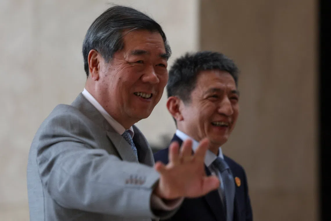 Chinese Vice Premier He Lifeng waves to photographers with China's top trade negotiator Li Chenggang during a break of trade talks between the United States and China, at Kuala Lumpur, Malaysia October 25, 2025. REUTERS/Hasnoor Hussain
