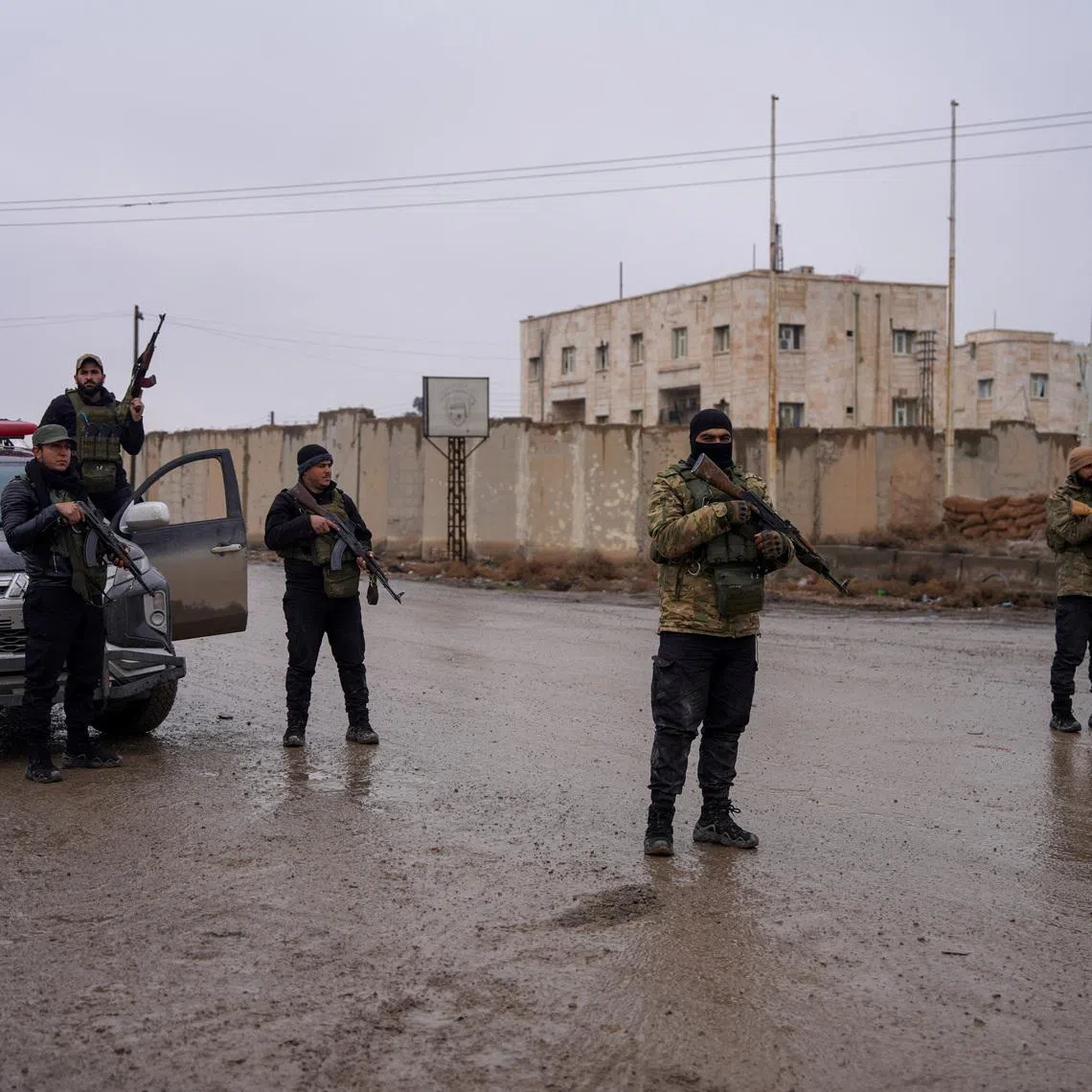 Members of the Syrian security forces stand guard outside al-Aqtan prison, where some Islamic State detainees are held, in Raqqa, Syria January 23, 2026. REUTERS/Karam al-Masri
