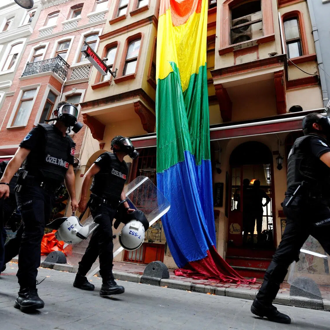 A file photo shows riot police chasing LGBT rights activists as they try to gather for a pride parade in Istanbul on June 26, 2016.