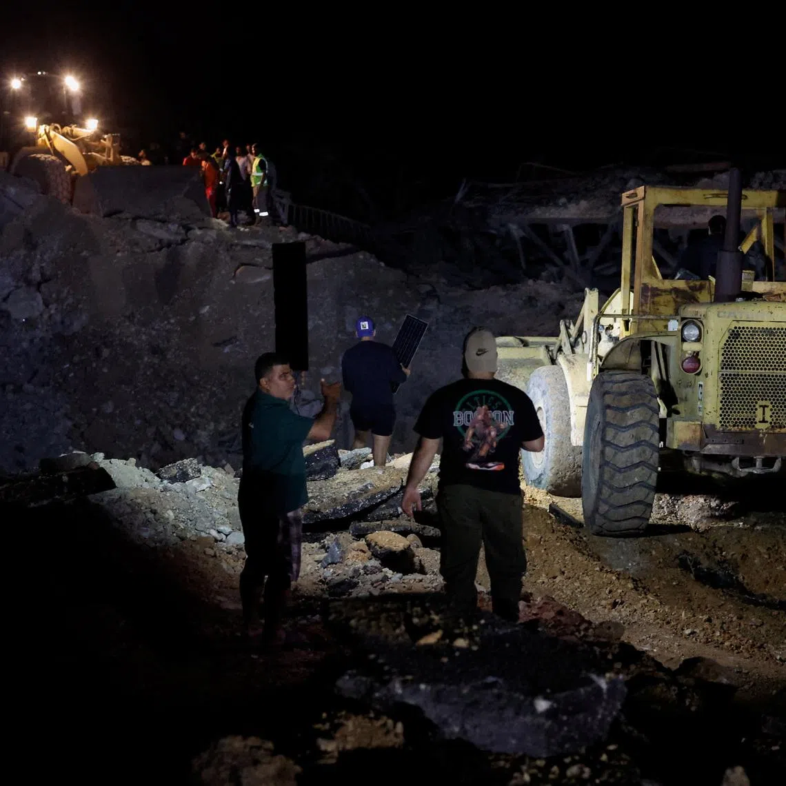 People working to repair a bridge in Qasmiyeh linking southern Lebanon to the rest of the country on April 17.