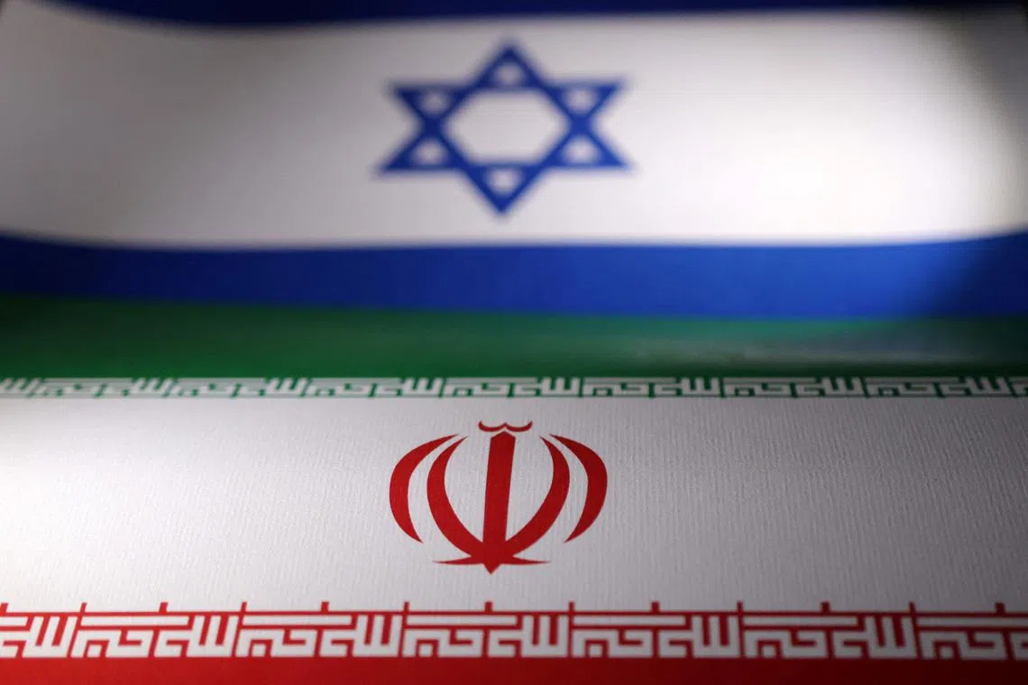 Israeli and Iranian flags are seen in this illustration taken, April 24, 2024. REUTERS/Dado Ruvic/Illustration/File Photo