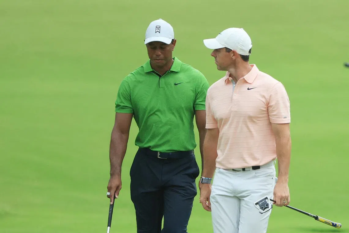 Tiger Woods and Rory McIlroy of Northern Ireland walk on the 14th hole during the second round of the 2022 PGA Championship.
