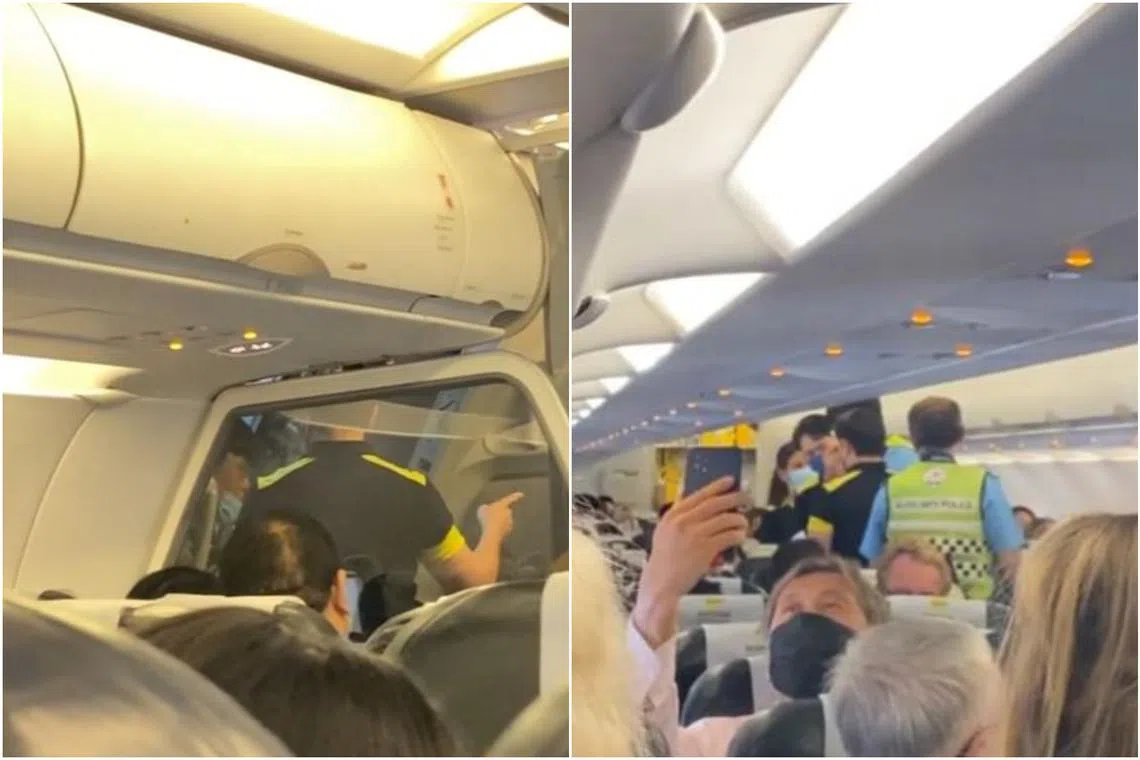 The video shows auxiliary police boarding the plane after it landed to escort several passengers out.