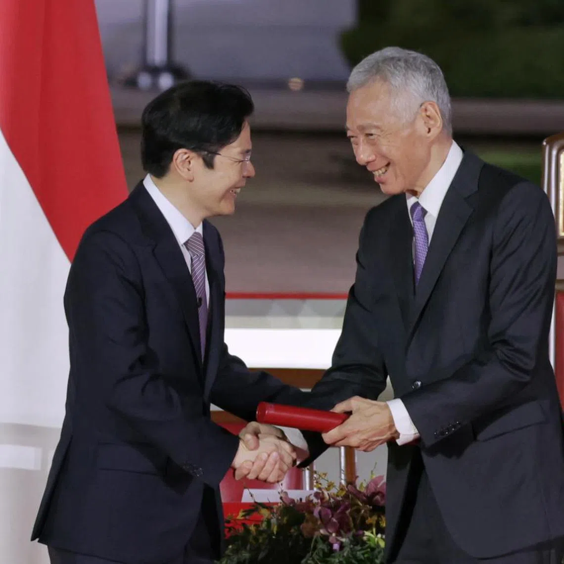 Senior Minister Lee Hsien Loong shaking hands with Prime Minister Lawrence Wong after receiving the instrument of appointment from President Tharman Shanmugaratnam during the swearing-in ceremony at the Istana on May 15, 2024. ST PHOTO: KEVIN LIM
