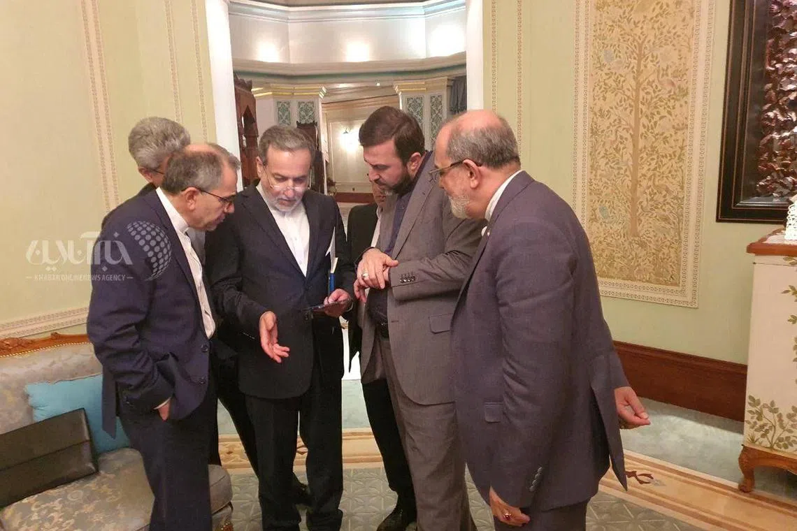 Iranian Foreign Minister Abbas Araghchi speaking to members of the Iranian delegation, after the nuclear talks in Muscat, Oman, on April 12.