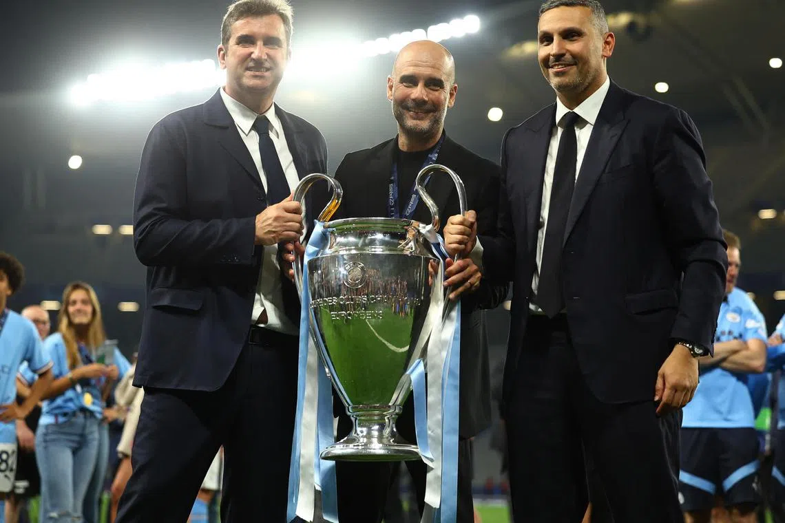Manchester City chief executive Ferran Soriano, manager Pep Guardiola and chairman Khaldoon Al Mubarak celebrates with the trophy after winning the Champions League.