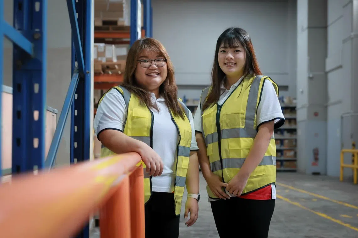 GKE Corporation staffs Jermaine Wen (glasses) and Zoe Li working at the logistics firm’s warehouse, Jan 5, 2024.