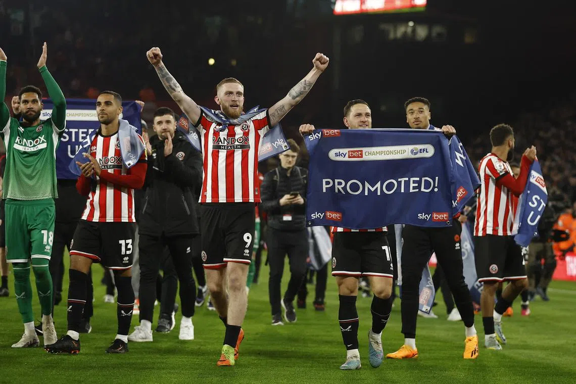 Sheffield United players celebrate promotion to the premier league after their match against West Brome