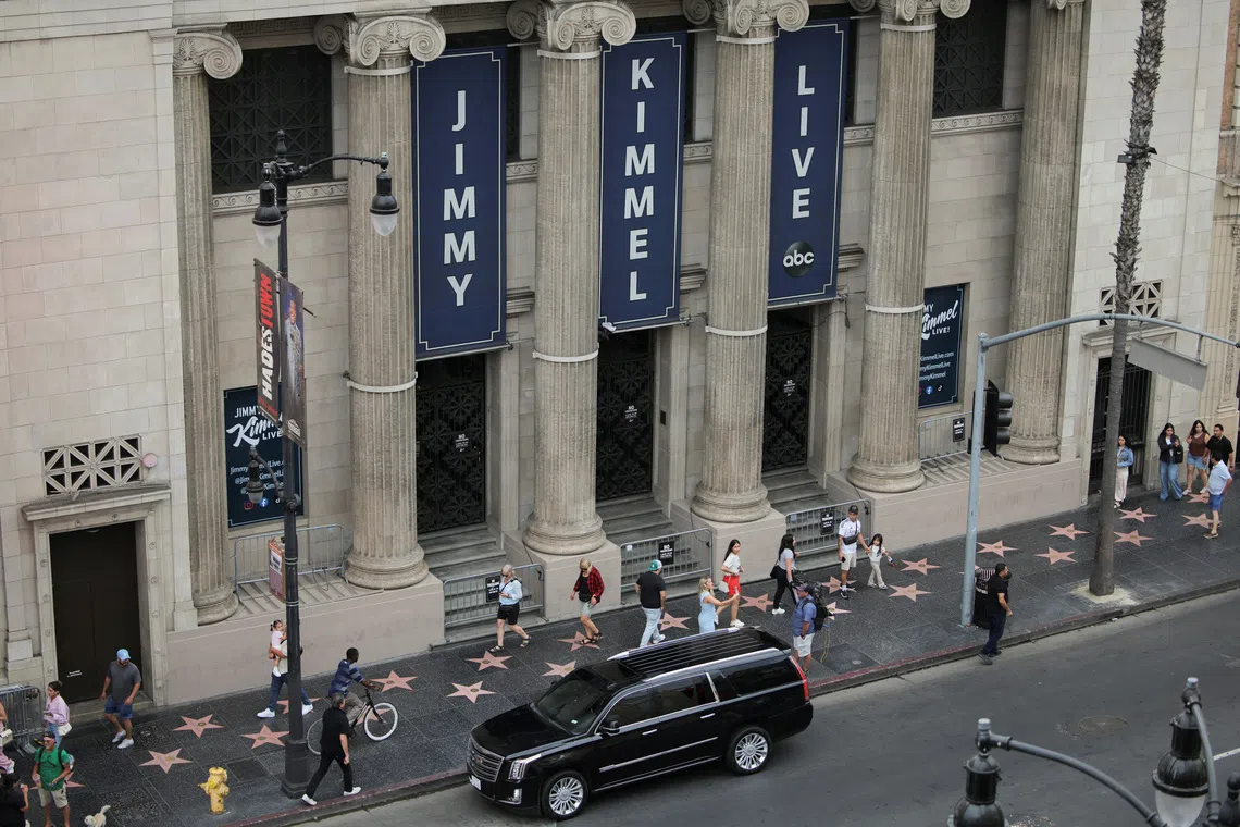 People walk past the El Capitan Entertainment Centre, where \"Jimmy Kimmel Live!\" is recorded for broadcast, on Hollywood Boulevard in Los Angeles, California, U.S. September 17, 2025.  REUTERS/Daniel Cole