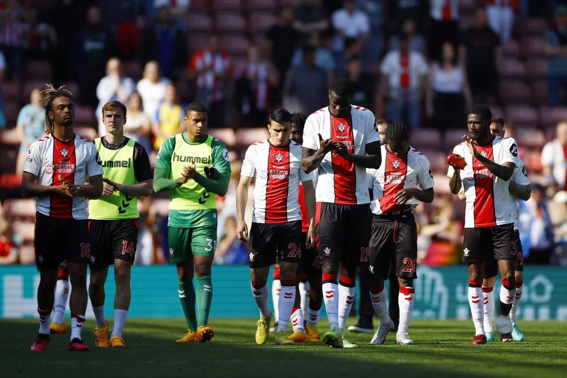 Southampton players look dejected after losing the match and being relegated from the Premier League on Saturday.