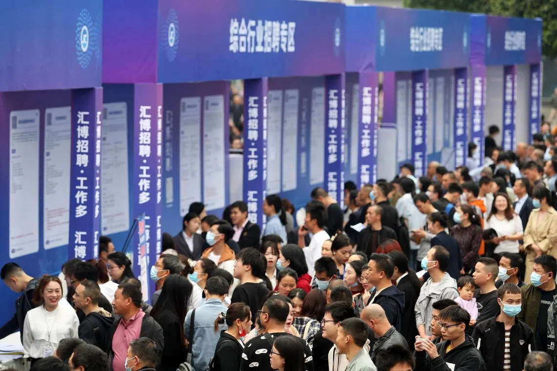 People attend a job fair in China's southwestern city of Chongqing on April 11, 2023..