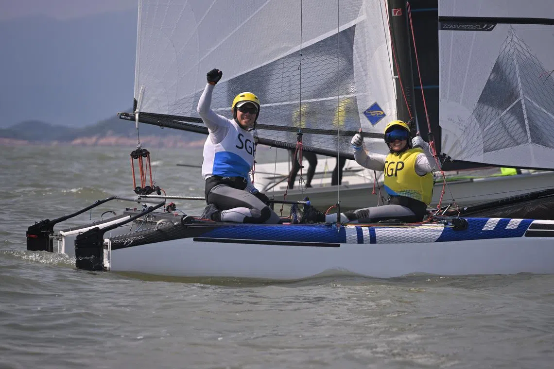 Singapore's Justin Liu (left) and Denise Lim going up against China's Zhao Huancheng and Wang Saibo in the Nacra 17 at the Asian Games. 