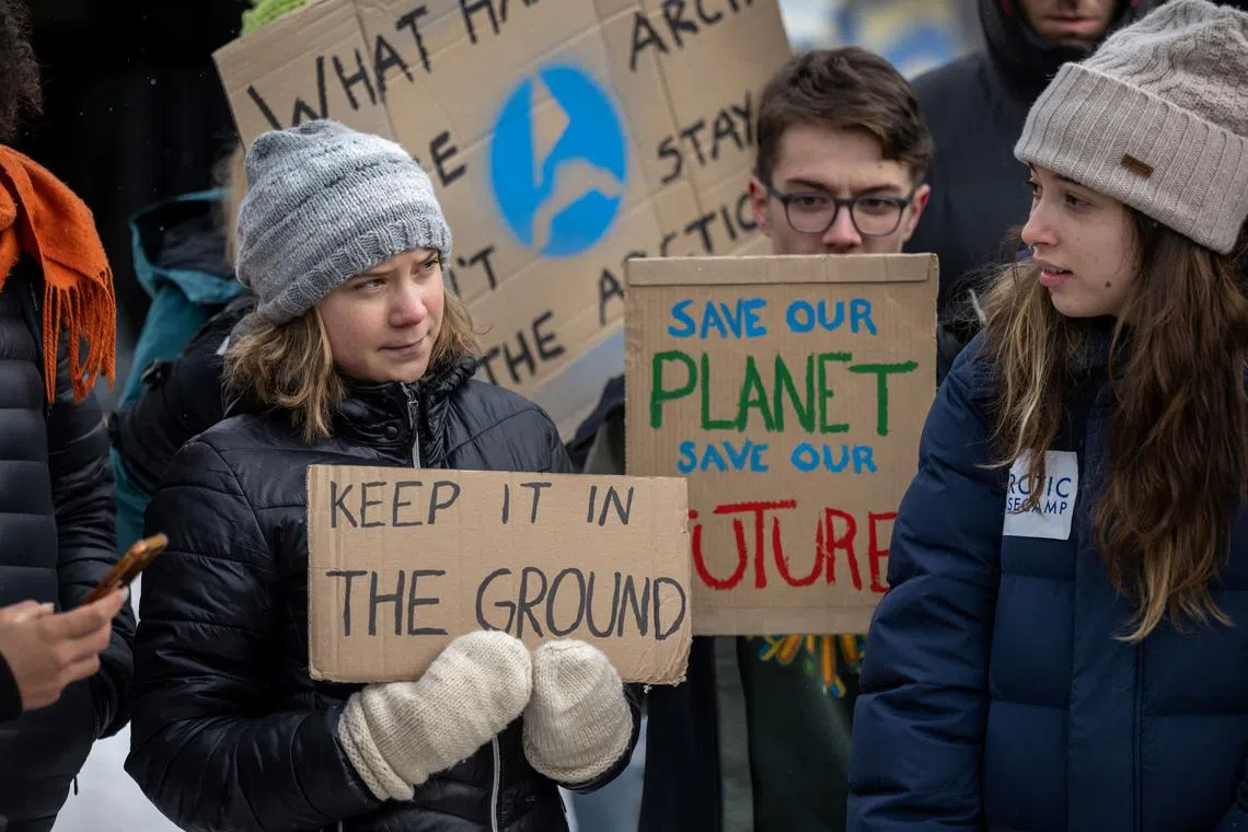Sweden's Greta Thunberg (left) and other young climate activists of the "Fridays for Future" movement stage an unauthorised demonstration on the closing day of the World Economic Forum (WEF) annual meeting in Davos on Jan 20, 2023. 