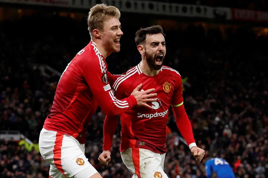 Manchester United's Bruno Fernandes celebrates scoring their second goal with teammate Rasmus Hojlund.