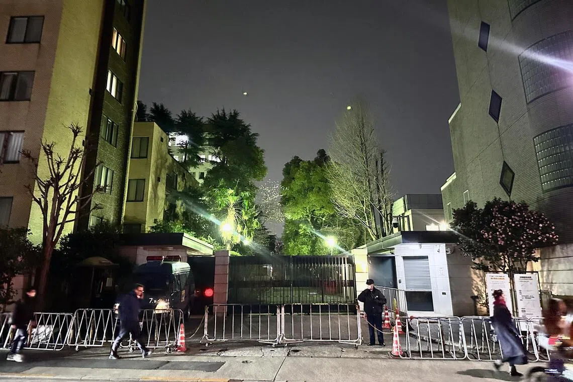 Police officers stand guard in front of the Chinese Embassy in Tokyo, Japan.