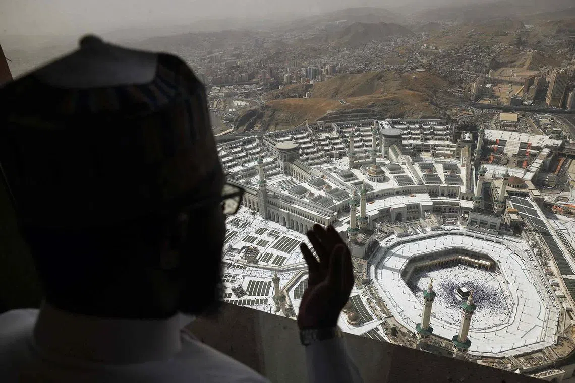 A Muslim pilgrim overlooking the Kaaba, Islam's holiest shrine, at the Grand Mosque complex in the holy city of Mecca on June 2, 2025, ahead of the annual Hajj pilgrimage.
