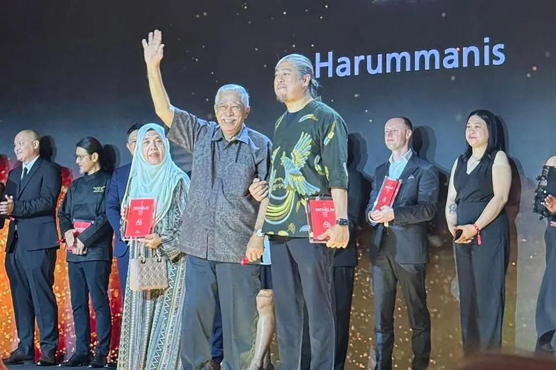 Chef Akmal Anuar (right) and his parents at the Michelin Guide ceremony in Dubai. 