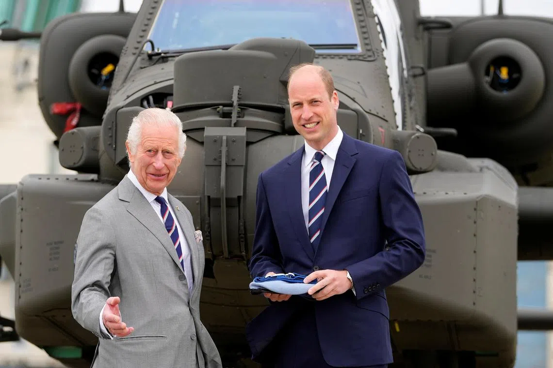 Britain's King Charles III officially hands over the role of Colonel-in-Chief of the Army Air Corps to Prince William, Prince of Wales, in front of a helicopter at the Army Aviation Centre in Middle Wallop, Britain May 13, 2024. Kin Cheung/Pool via REUTERS