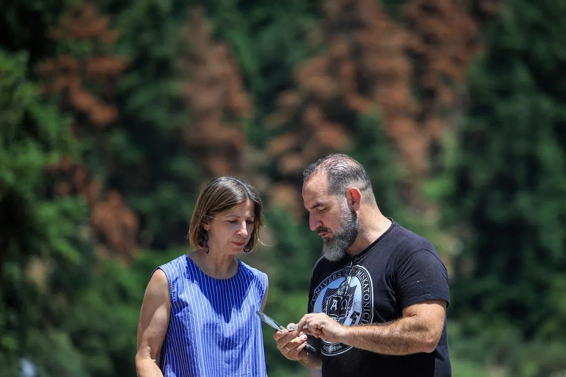 FILE PHOTO: Dimitrios Avtzis, a forest entomologist and research director at the Greek Agricultural Organization Demeter, talks with Katerina Kolirou, head of the local forest service near the village of Kalavryta, Peloponnese region, Greece, July 9, 2025. REUTERS/Louisa Gouliamaki/File Photo