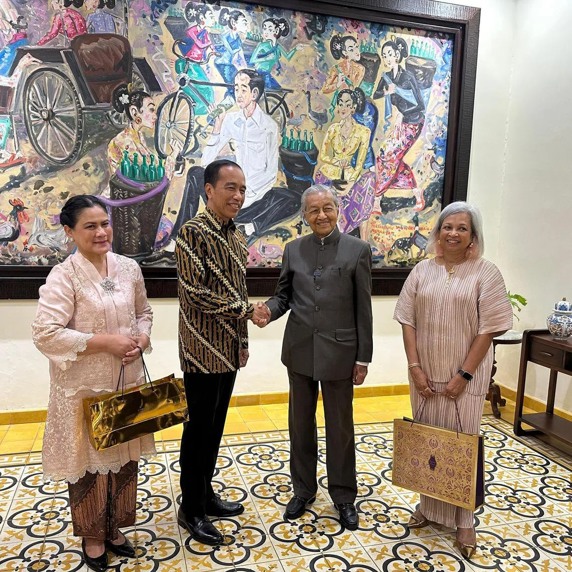 Former Indonesia president Joko Widodo (second from L) shake hands with former Malaysian prime minister Tun Mahathir Mohamad (second from R), accompanied by Joko's wife, Iriana (L) and Mahathir's daughter, Marina (R), at Joko's home on Feb 26, 2025. 
 PHOTO: SYARIF M. FITRIANSYAH