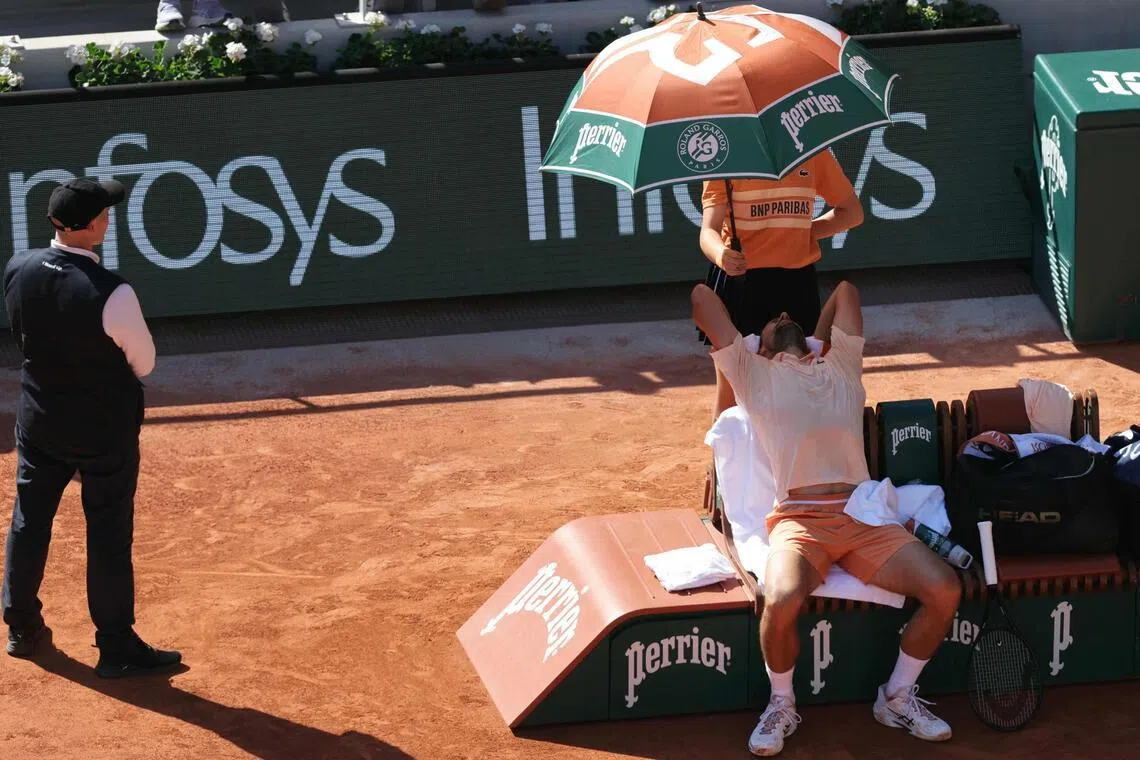 Serbia's Novak Djokovic relaxing between games during his 6-3, 6-2, 6-7 (7-9), 6-3 French Open second-round win over world No. 74 Valentin Royer on Court Philippe-Chatrier at the Roland Garros Complex in Paris on May 27, 2026.