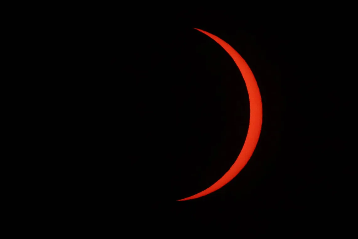 The Moon uncovers the Sun in the moments following totality of the solar eclipse as seen from La Zurriola beach in San Sebastian, on August 12, 2026. Millions of Europeans contemplated the sky in awe today during a rare total solar eclipse that will plunge a swathe of Spain into an eerie daytime darkness. The shadow cast when the Moon covers the Sun began in Russia's remote Arctic north at around 1700 GMT and continued in an arc through Greenland and Iceland. Spain is where most people viewed the total eclipse, which crossed the country diagonally from the northern Atlantic coast to the Mediterranean Sea, where it vanished at around 1830 GMT. (Photo by Thomas COEX / AFP)