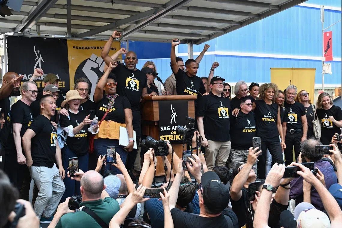 SAG-AFTRA members pose during a strike rally at New York's Times Square on July 25, 2023.