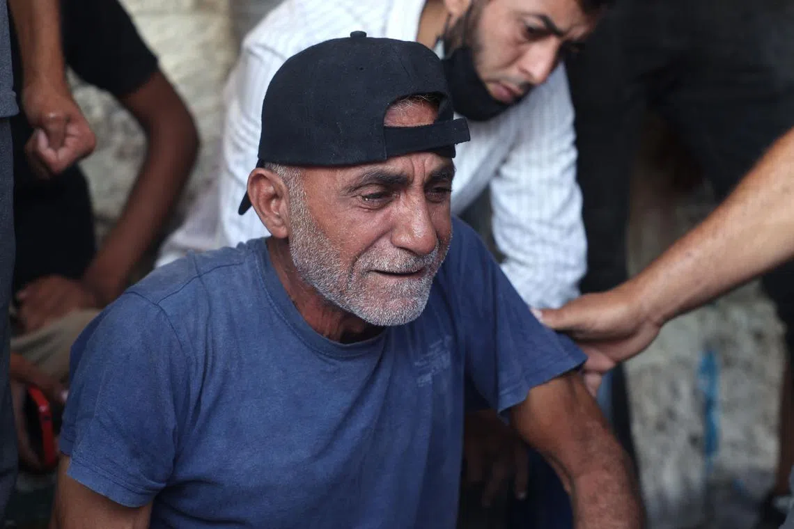 A Palestinian man mourns over family members who died during Israeli bombardment on Sept 7.