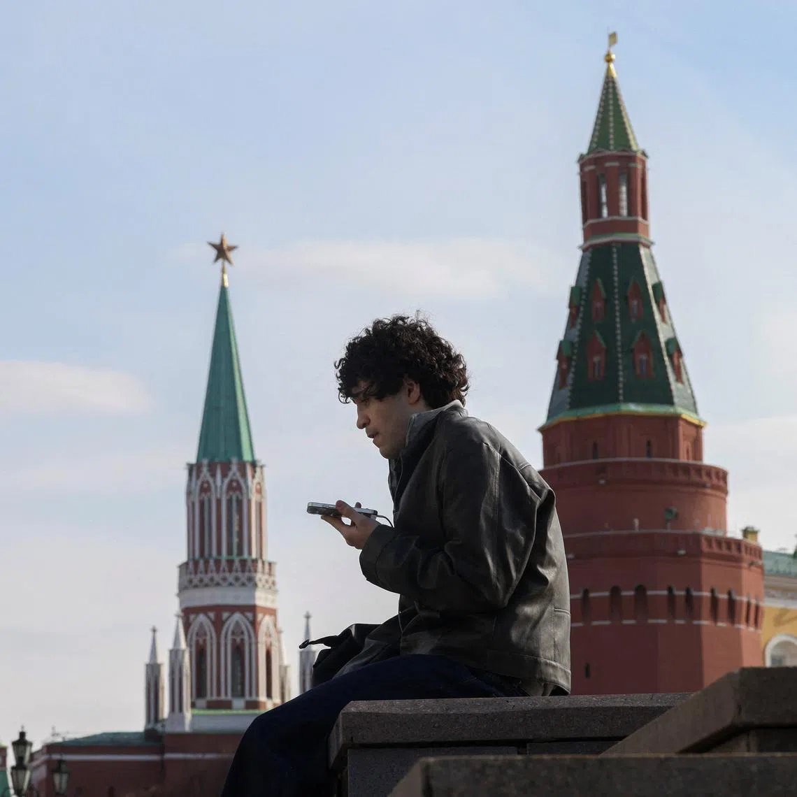 A man checks his mobile phone in central Moscow, Russia March 17, 2026.